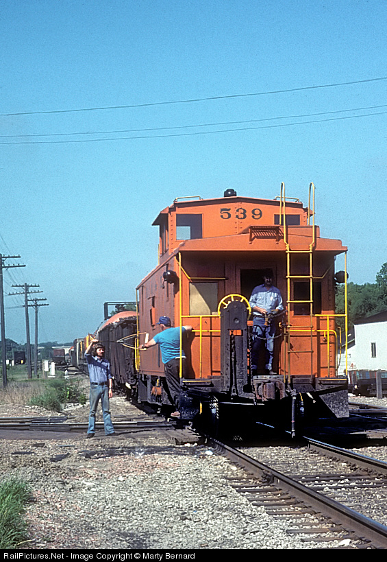 This is EJ&E #539 with a large offset cupola at Rondout, IL, 1977 – cupola towards the rear, marker lights placed as such.